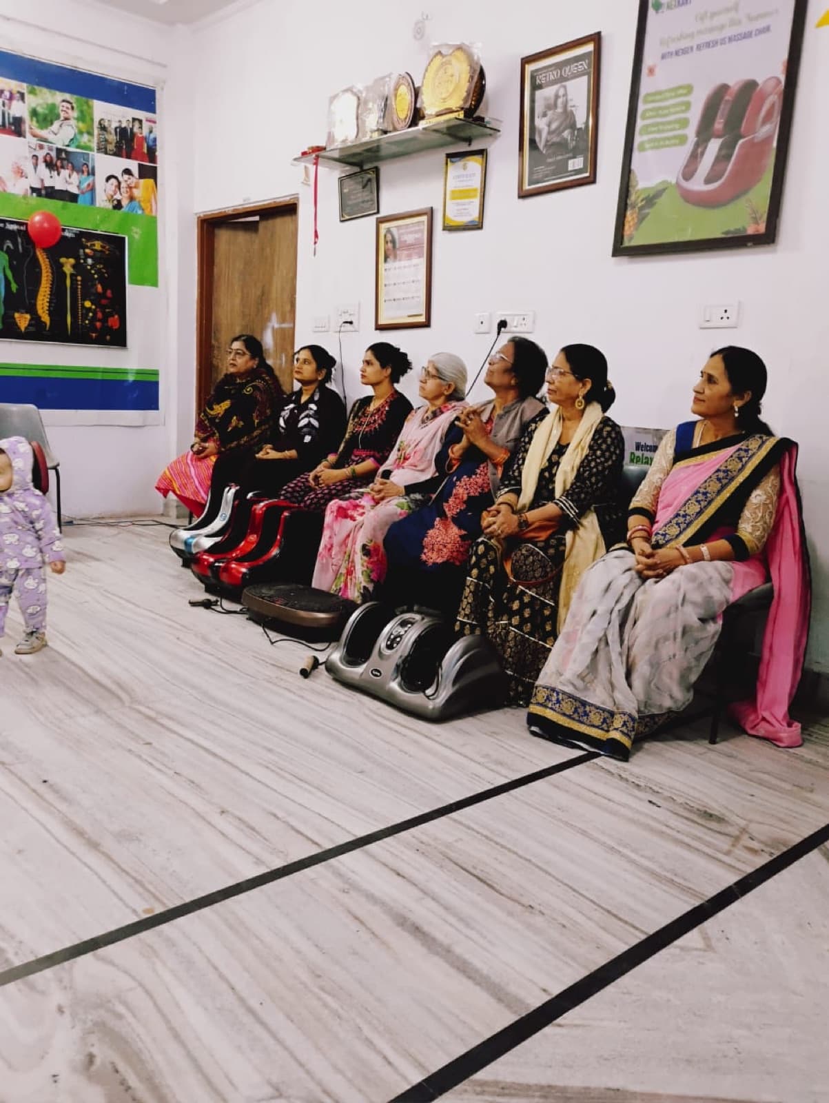 A row of guests using NexGen foot massagers at the Malviya Nagar centre