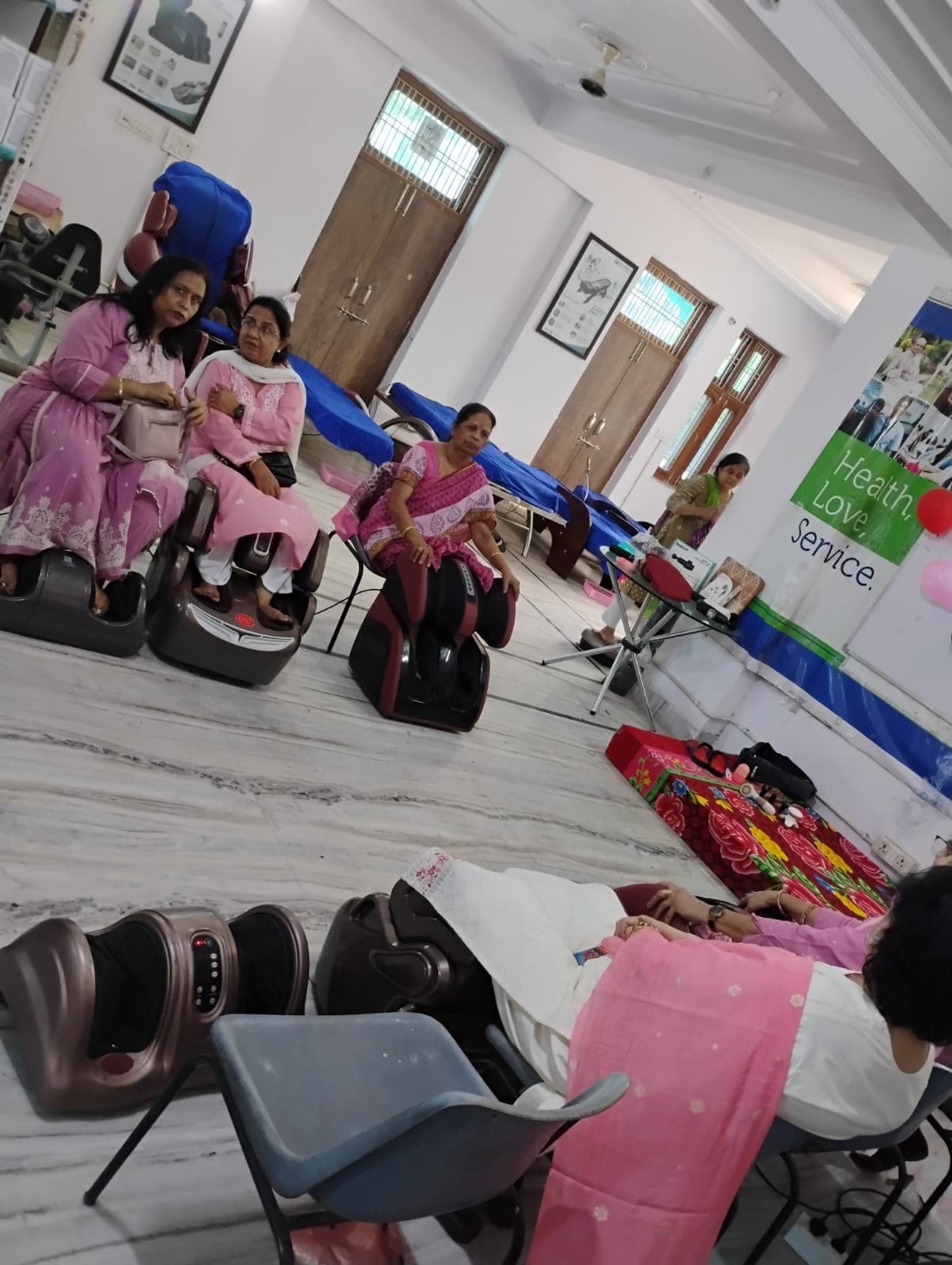 Visitors relaxing on NexGen foot and leg massagers at the Jaipur showroom